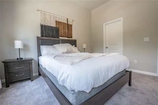 a bedroom with a bed and a night stand