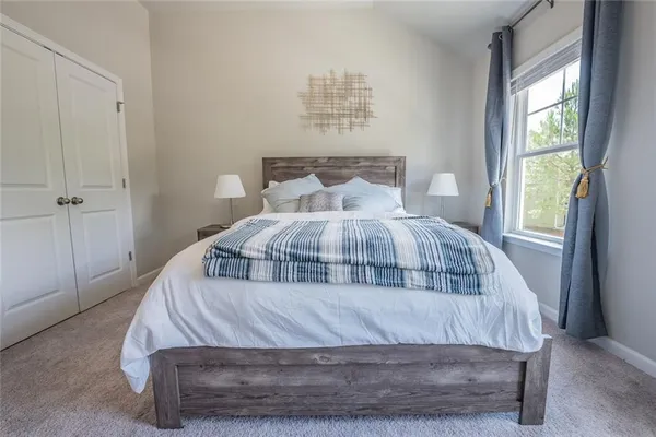 a bedroom with a bed and window
