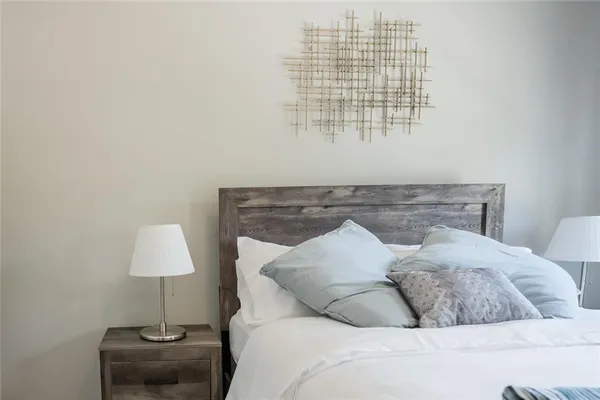 a bed sitting in a bedroom next to a window