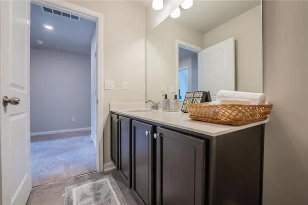 a bathroom with a granite countertop sink and a mirror