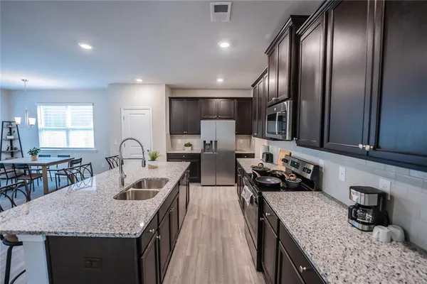 a kitchen with counter top space cabinets and stainless steel appliances