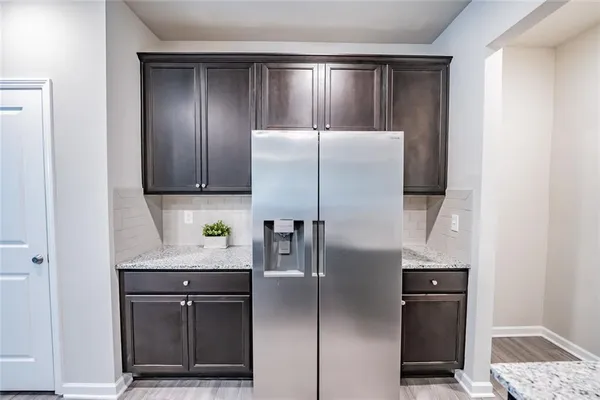 a kitchen with stainless steel appliances granite countertop a refrigerator and a stove