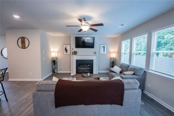 a living room with furniture fireplace and flat screen tv