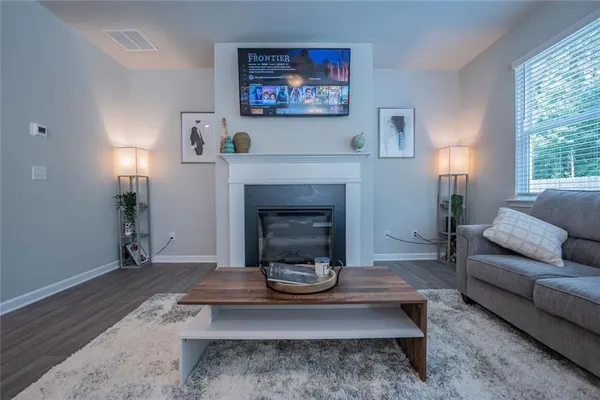a living room with furniture and a fireplace