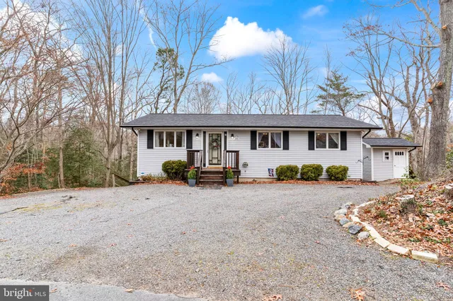 a view of a house with a yard covered in snow