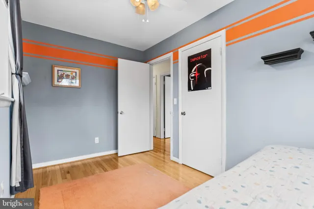 a bedroom with a bed and a painting on the wall