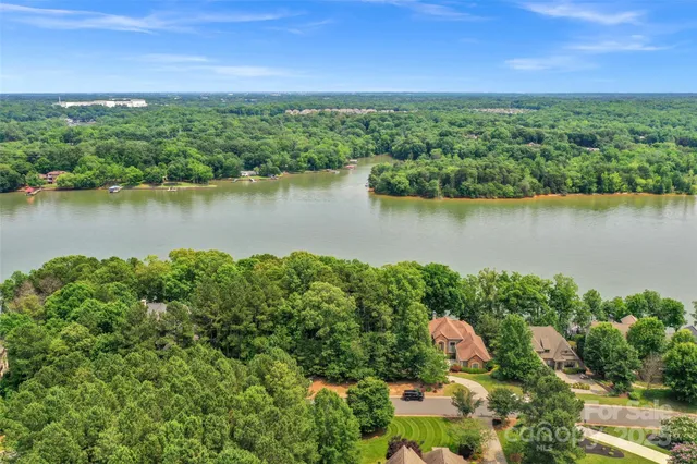 a view of a lake with houses in the back
