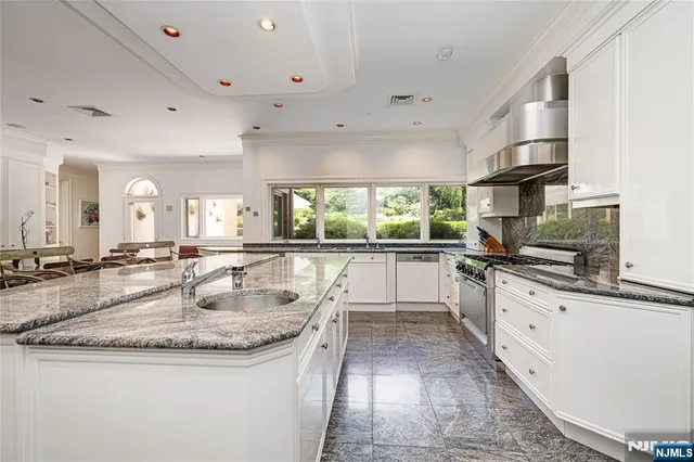 a kitchen with counter space sink stove and cabinets