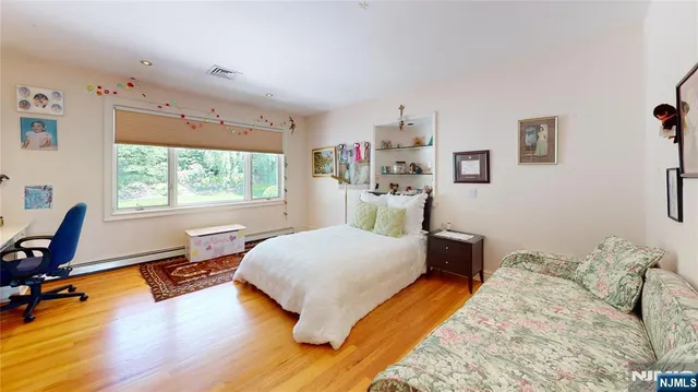 a bedroom with a bed and a large window