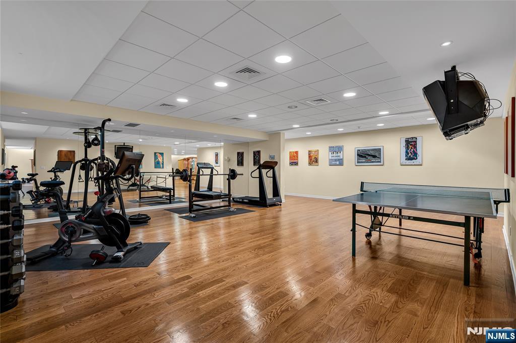 67 Adams Drive Cresskill, NJ 07626 - Photo 38 of 45 a view of a room with gym equipment and wooden floor