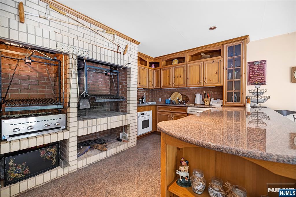 67 Adams Drive Cresskill, NJ 07626 - Photo 43 of 45 a kitchen with stainless steel appliances granite countertop a sink and a stove