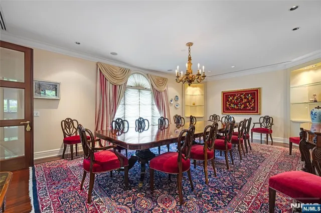a view of a dining room with furniture and chandelier