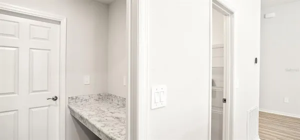 a view of a kitchen from the hallway