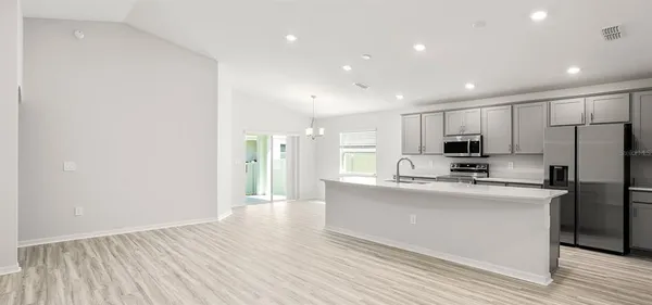 a kitchen with stainless steel appliances a refrigerator sink and microwave