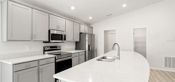 a kitchen with a sink a stove and refrigerator
