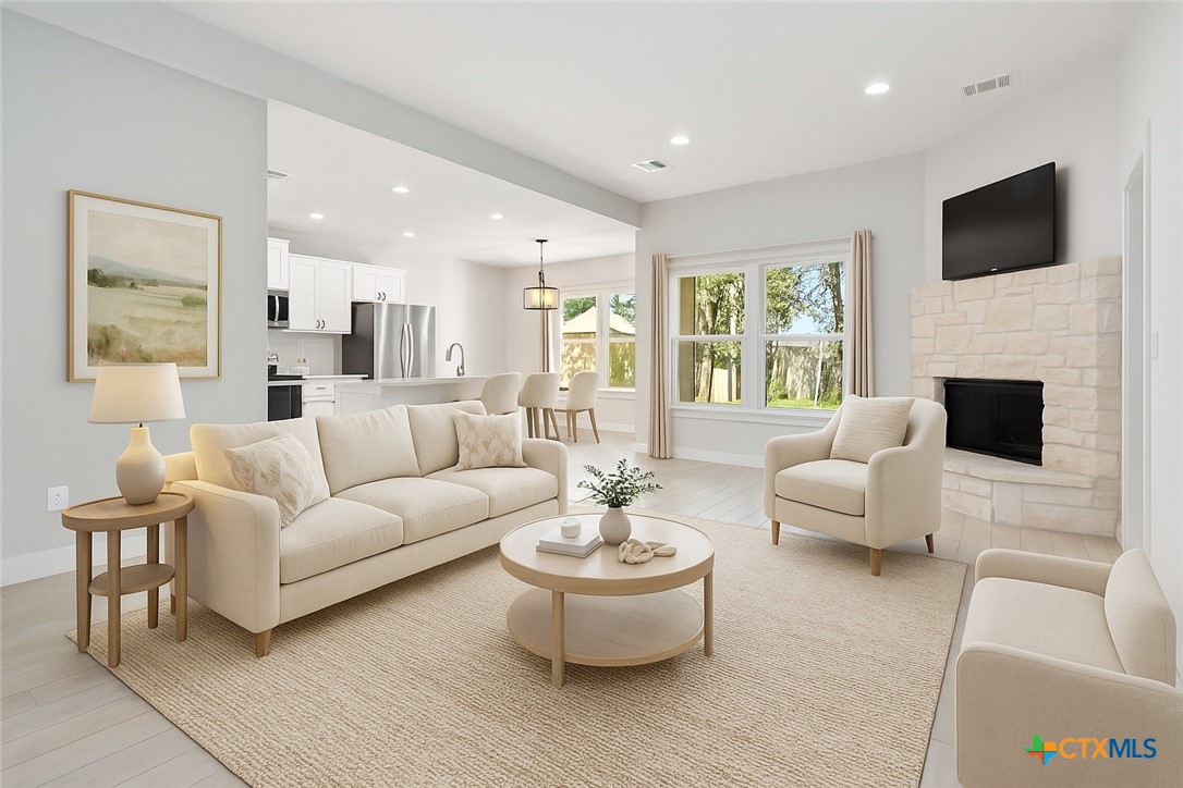 a living room with fireplace furniture and a flat screen tv