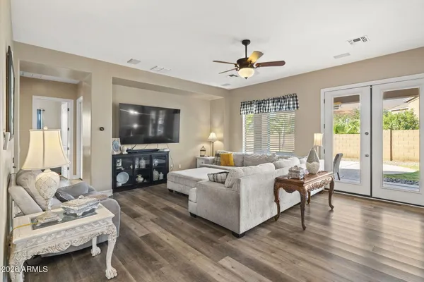 a living room with furniture a flat screen tv and a large window