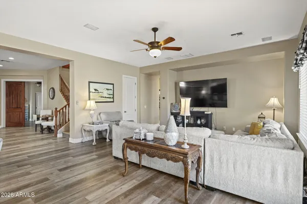 a living room with furniture a flat screen tv and a window