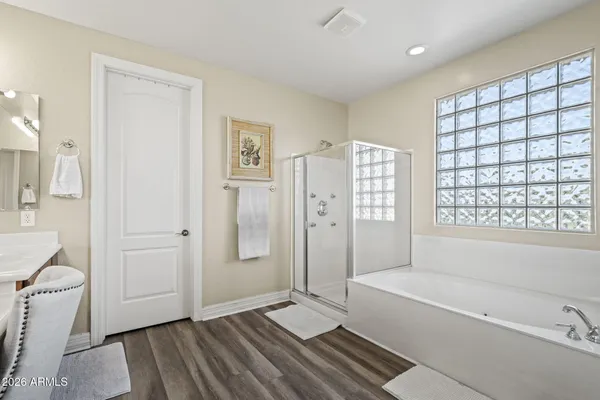 a spacious bathroom with a tub shower and sink