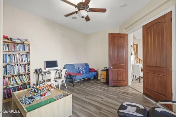 a living room with furniture and a book shelf