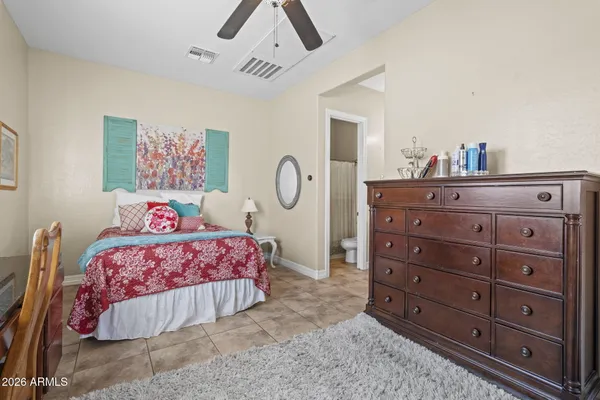 a bedroom with a bed and a painting on the wall