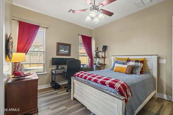 a bedroom with a bed and wooden floor