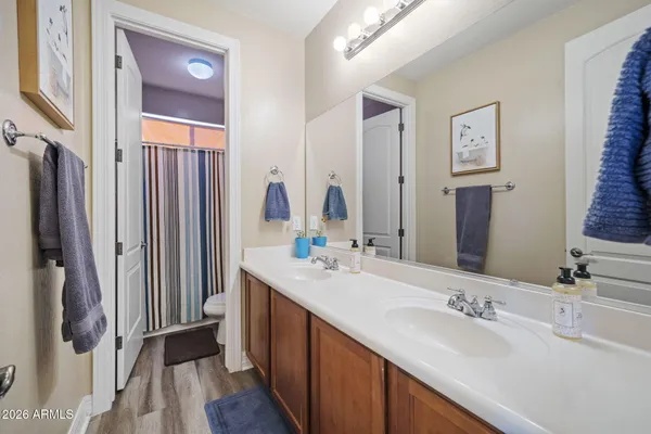 a bathroom with a double vanity sink and mirror