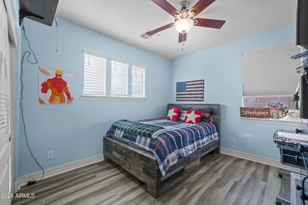 a bedroom with a bed and a chandelier