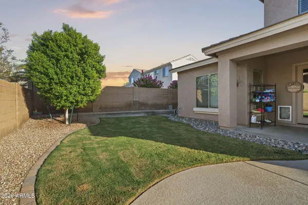 a view of a house with a yard and a garage