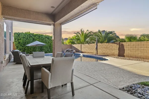 a view of a patio with a table and chairs