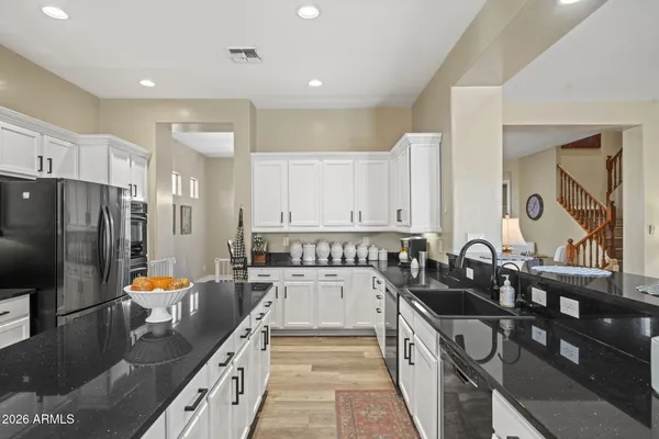 a kitchen with stainless steel appliances granite countertop a sink stove and refrigerator