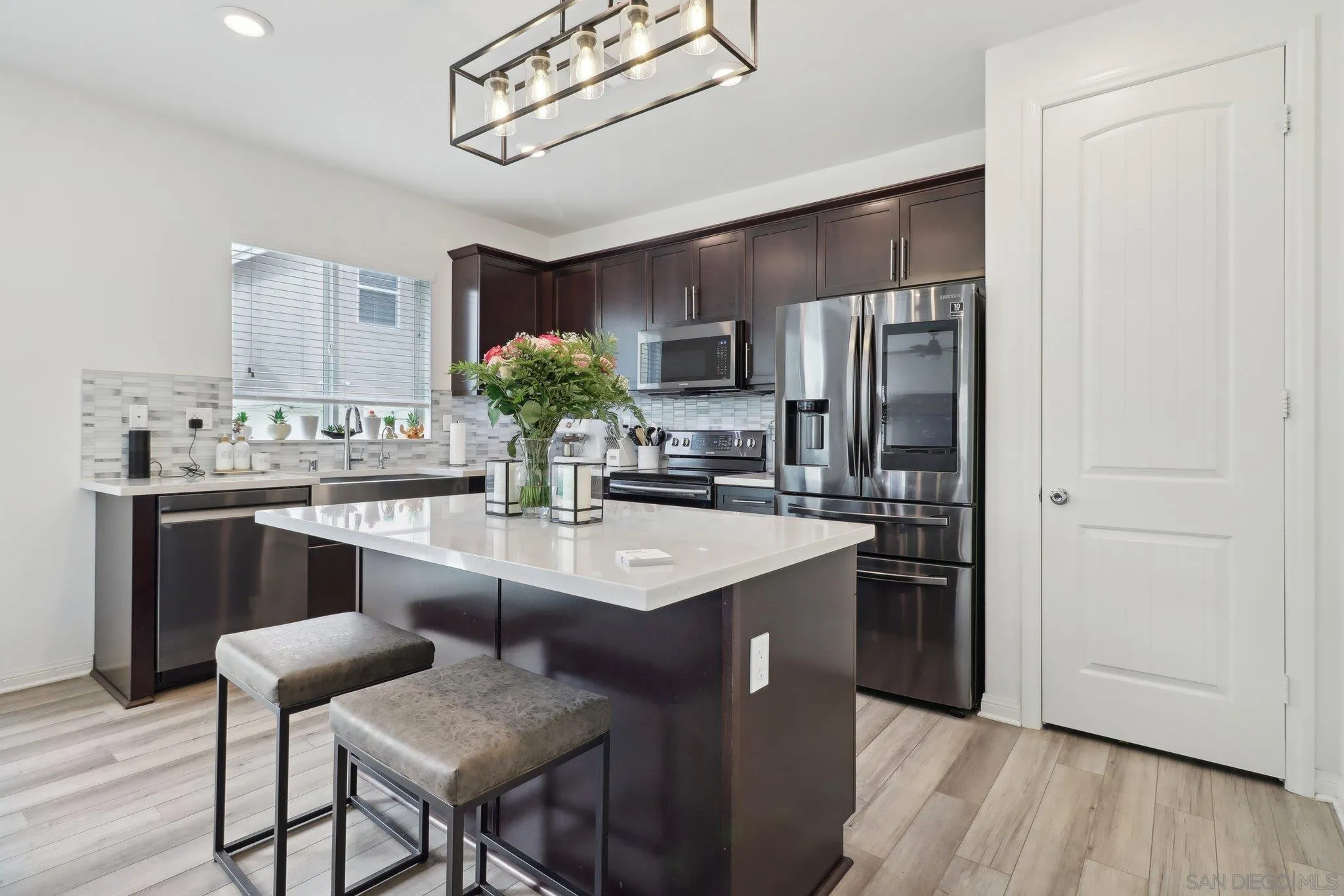 10645 Rhodes Lane Spring Valley, CA 91978 - Photo 12 of 38 a kitchen with kitchen island granite countertop a sink cabinets and stainless steel appliances