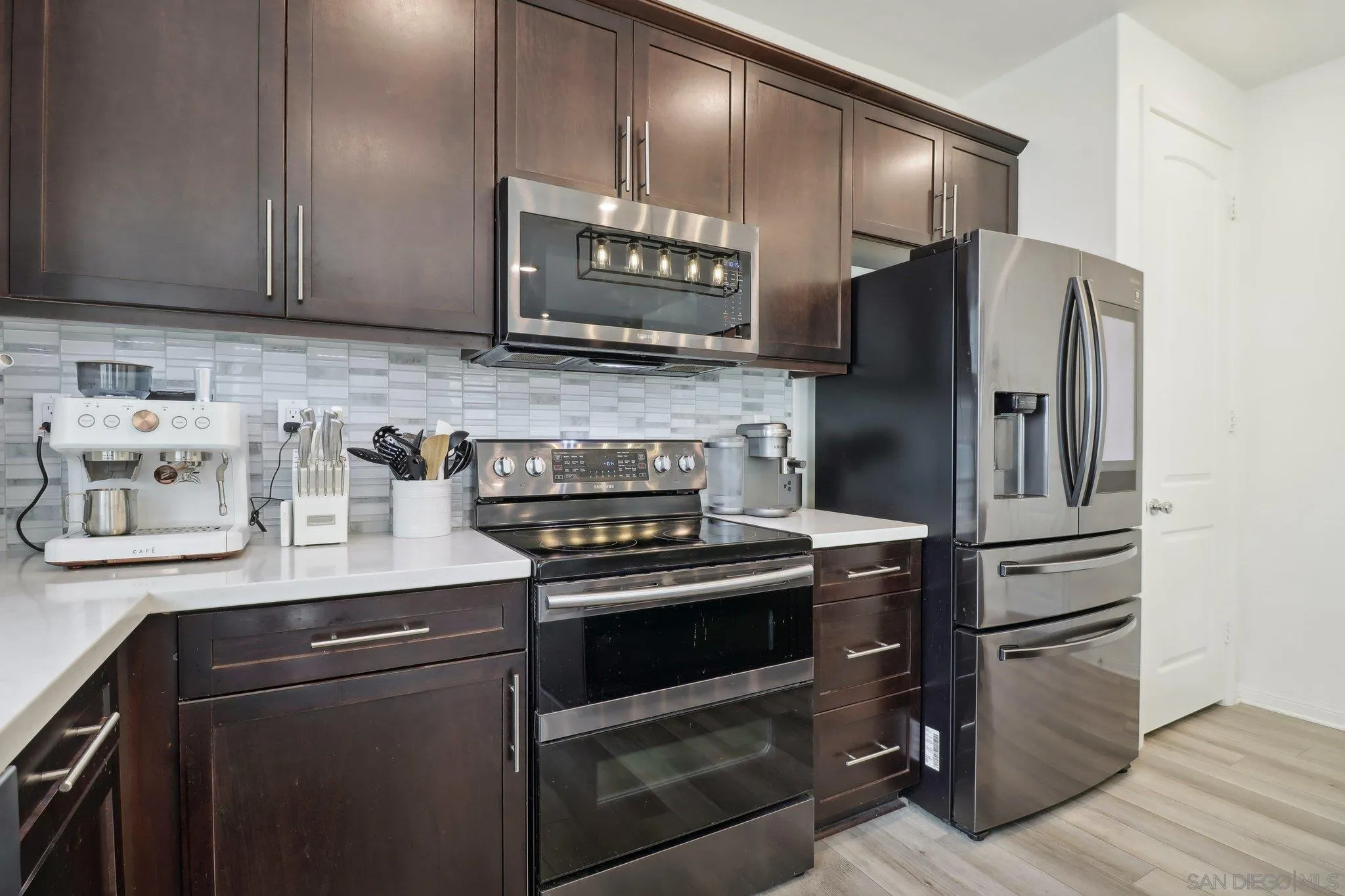 10645 Rhodes Lane Spring Valley, CA 91978 - Photo 13 of 38 a kitchen with stainless steel appliances and wooden cabinets