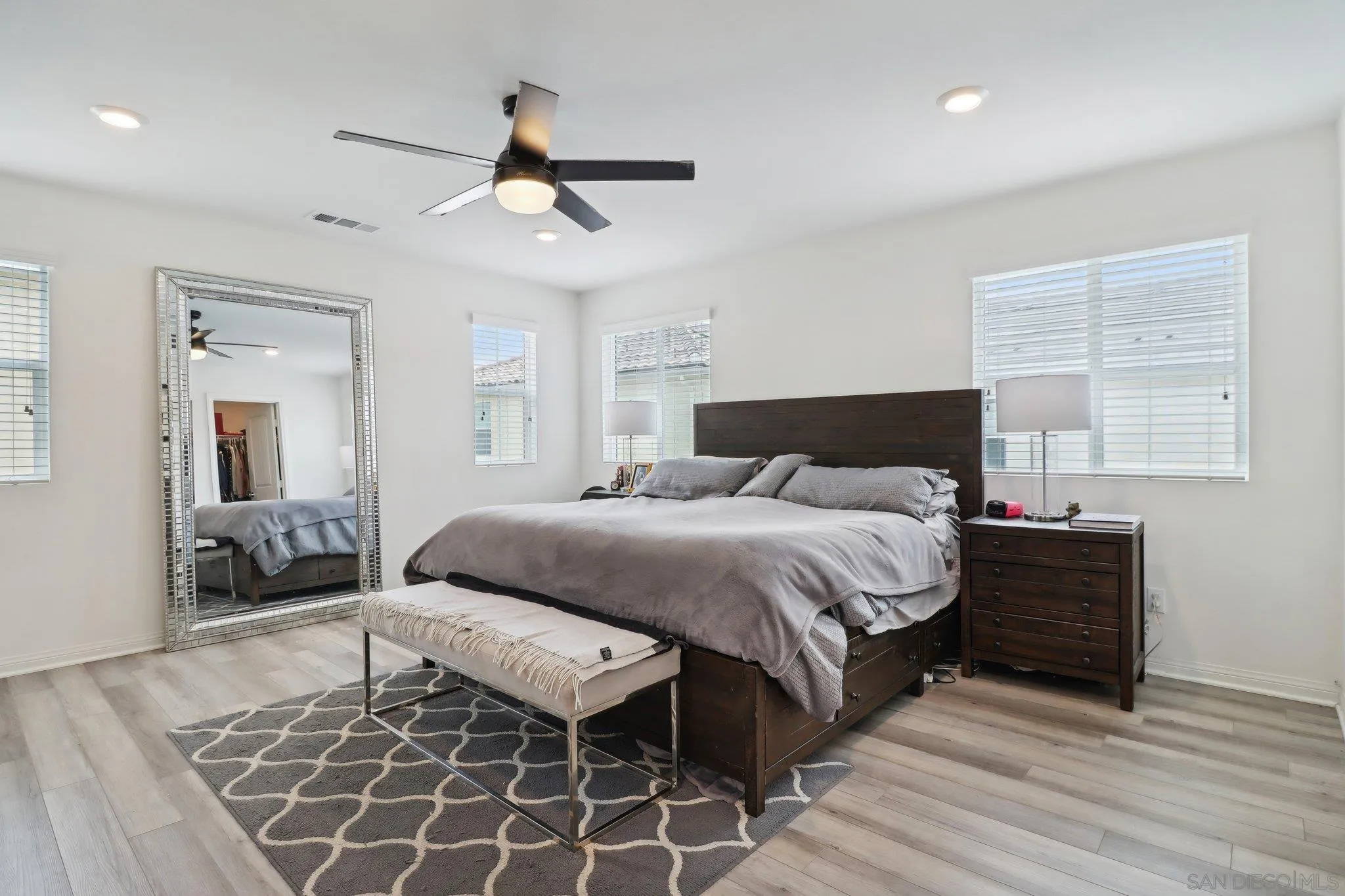10645 Rhodes Lane Spring Valley, CA 91978 - Photo 21 of 38 a spacious bedroom with a bed and wooden floor