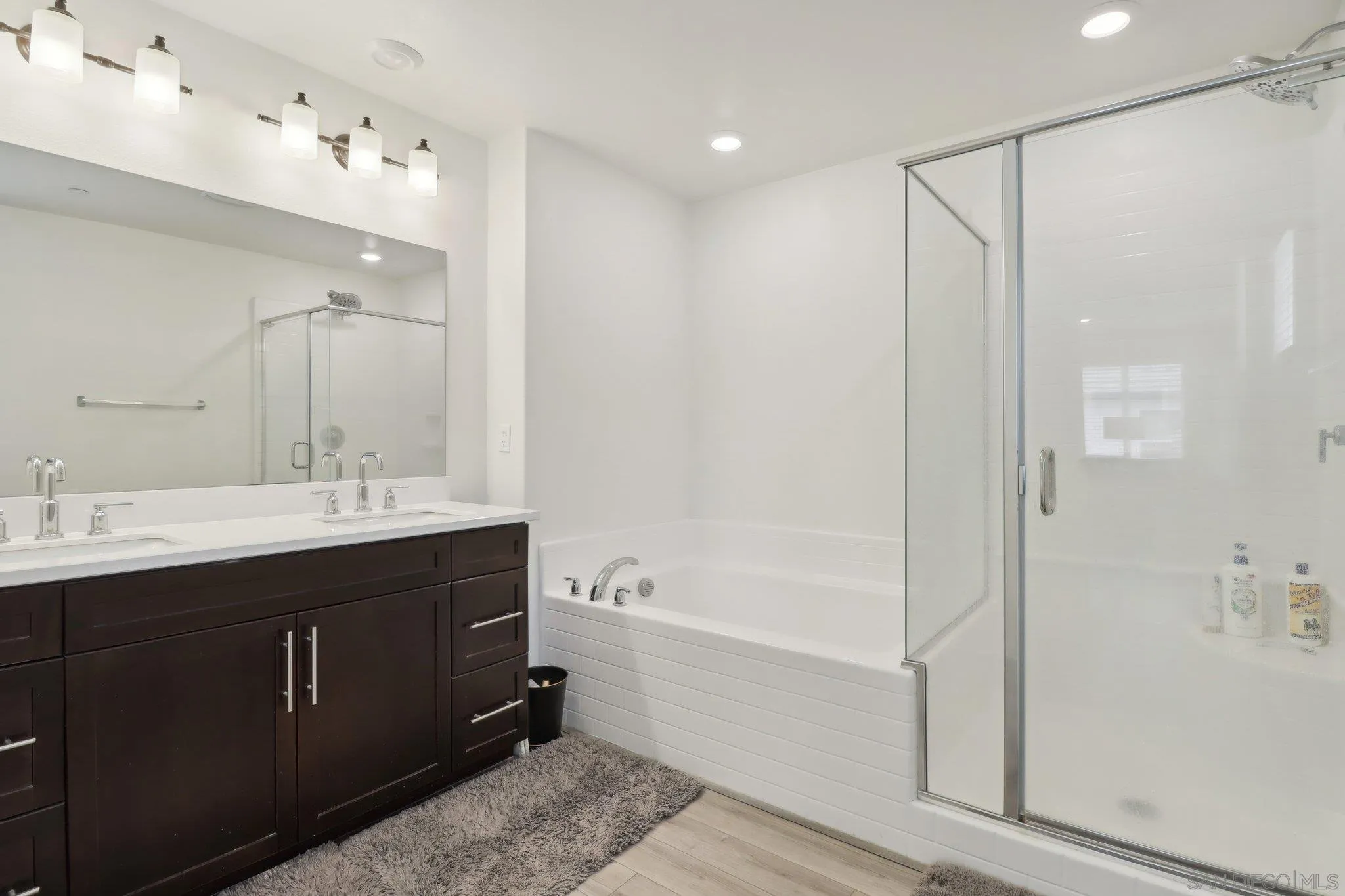 10645 Rhodes Lane Spring Valley, CA 91978 - Photo 24 of 38 a bathroom with a shower sink vanity and mirror