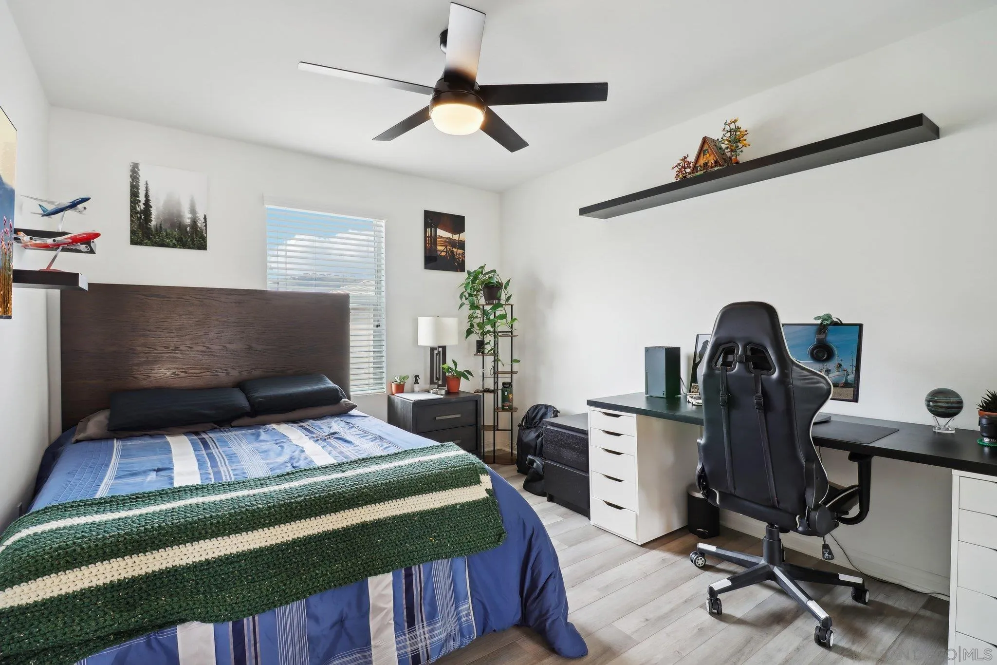 10645 Rhodes Lane Spring Valley, CA 91978 - Photo 27 of 38 a bedroom with a bed and a chandelier