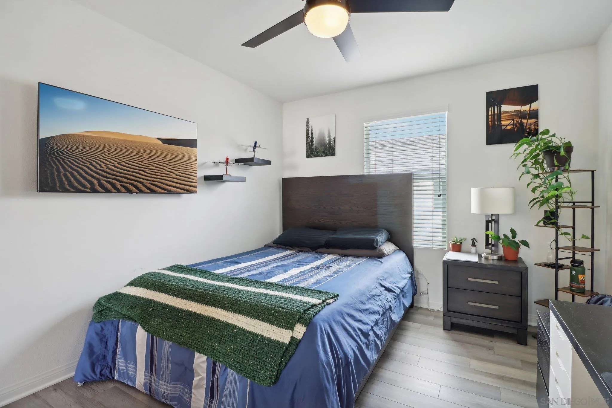 10645 Rhodes Lane Spring Valley, CA 91978 - Photo 28 of 38 a bedroom with a bed and wooden floor