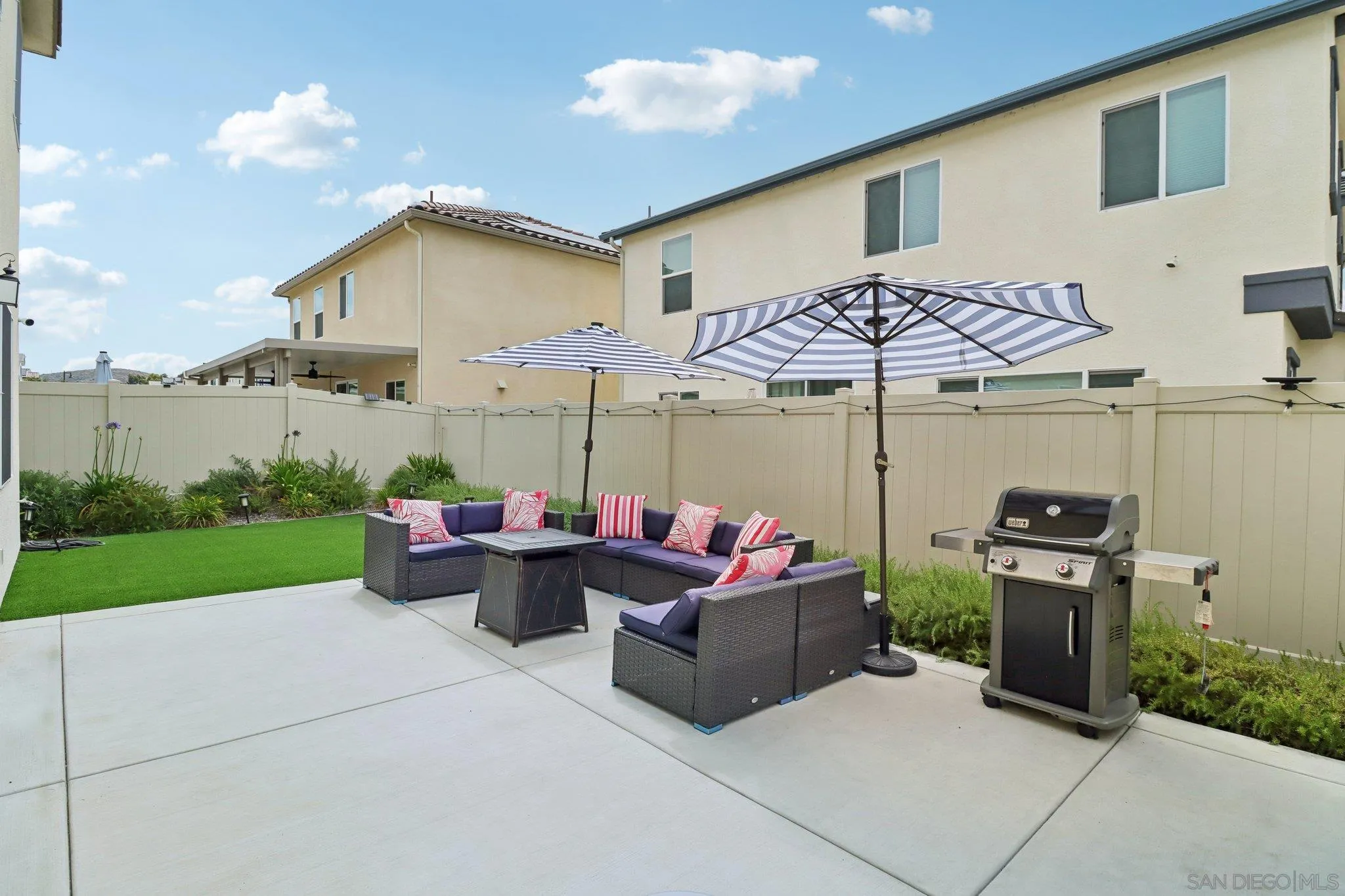 10645 Rhodes Lane Spring Valley, CA 91978 - Photo 36 of 38 a view of a patio with couches and chairs under an umbrella