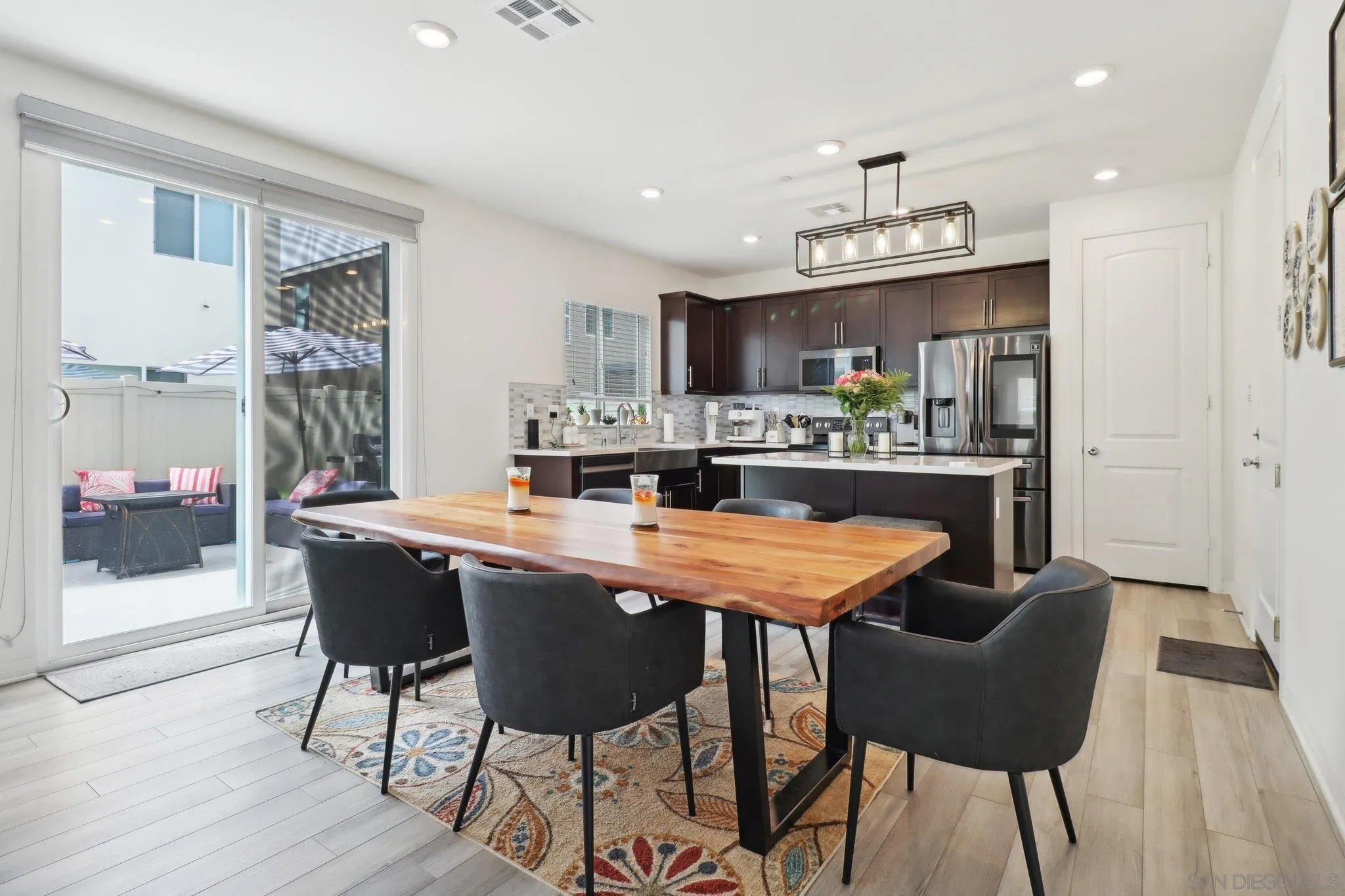 10645 Rhodes Lane Spring Valley, CA 91978 - Photo 6 of 38 a dining table with chairs and kitchen view