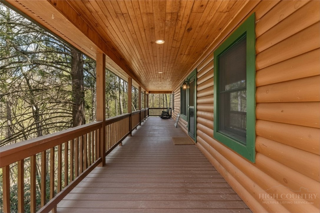 148 Woodby Ridge Road Vilas, NC 28692 - Photo 13 of 33 a view of a porch with wooden floor and stairs