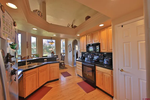 a large kitchen with stainless steel appliances lots of counter space and a sink