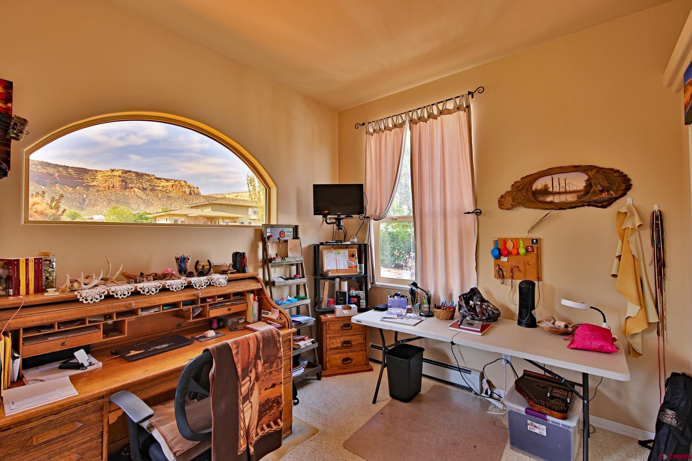 339 Canyon Rim Court Grand Junction, CO 81507 - Photo 17 of 40 a very nice looking room with many windows and furniture