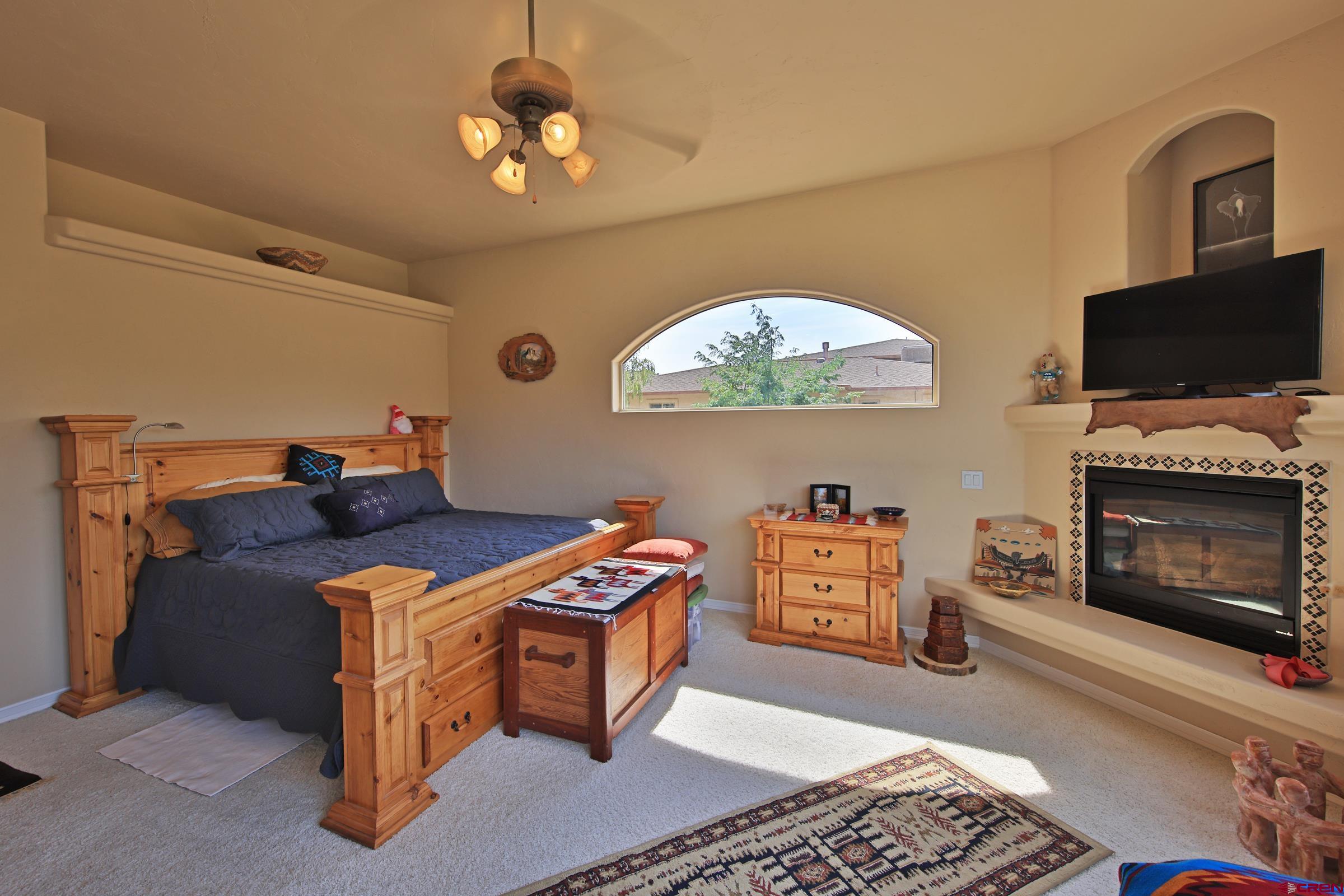 339 Canyon Rim Court Grand Junction, CO 81507 - Photo 21 of 40 a bed room with furniture and a fireplace