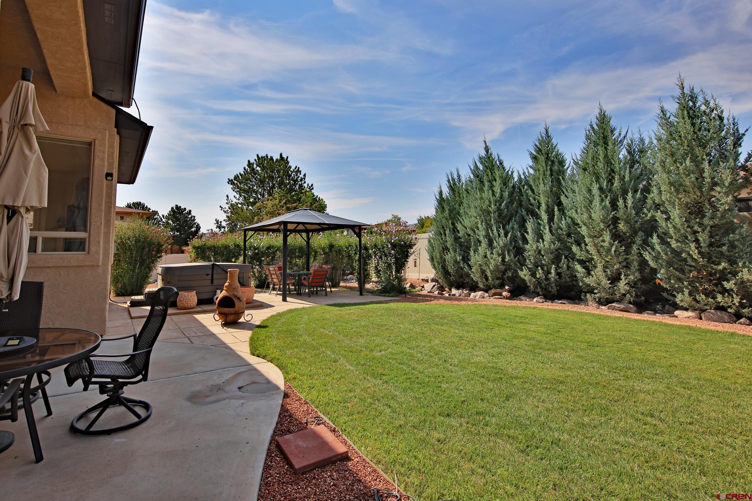 339 Canyon Rim Court Grand Junction, CO 81507 - Photo 26 of 40 a view of a backyard with sitting area