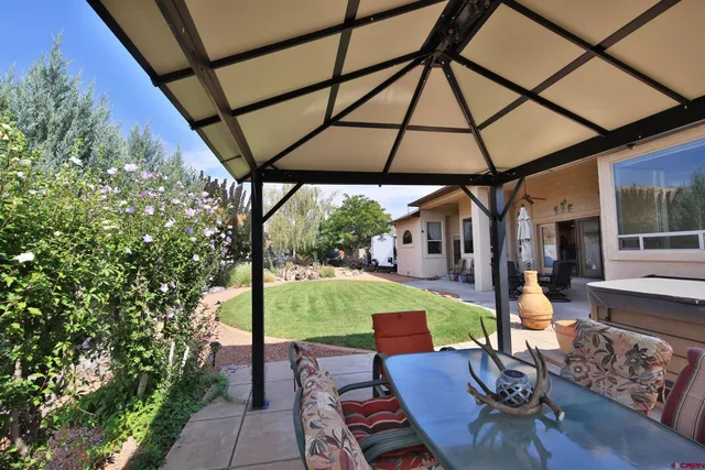 a backyard of a house with table and chairs