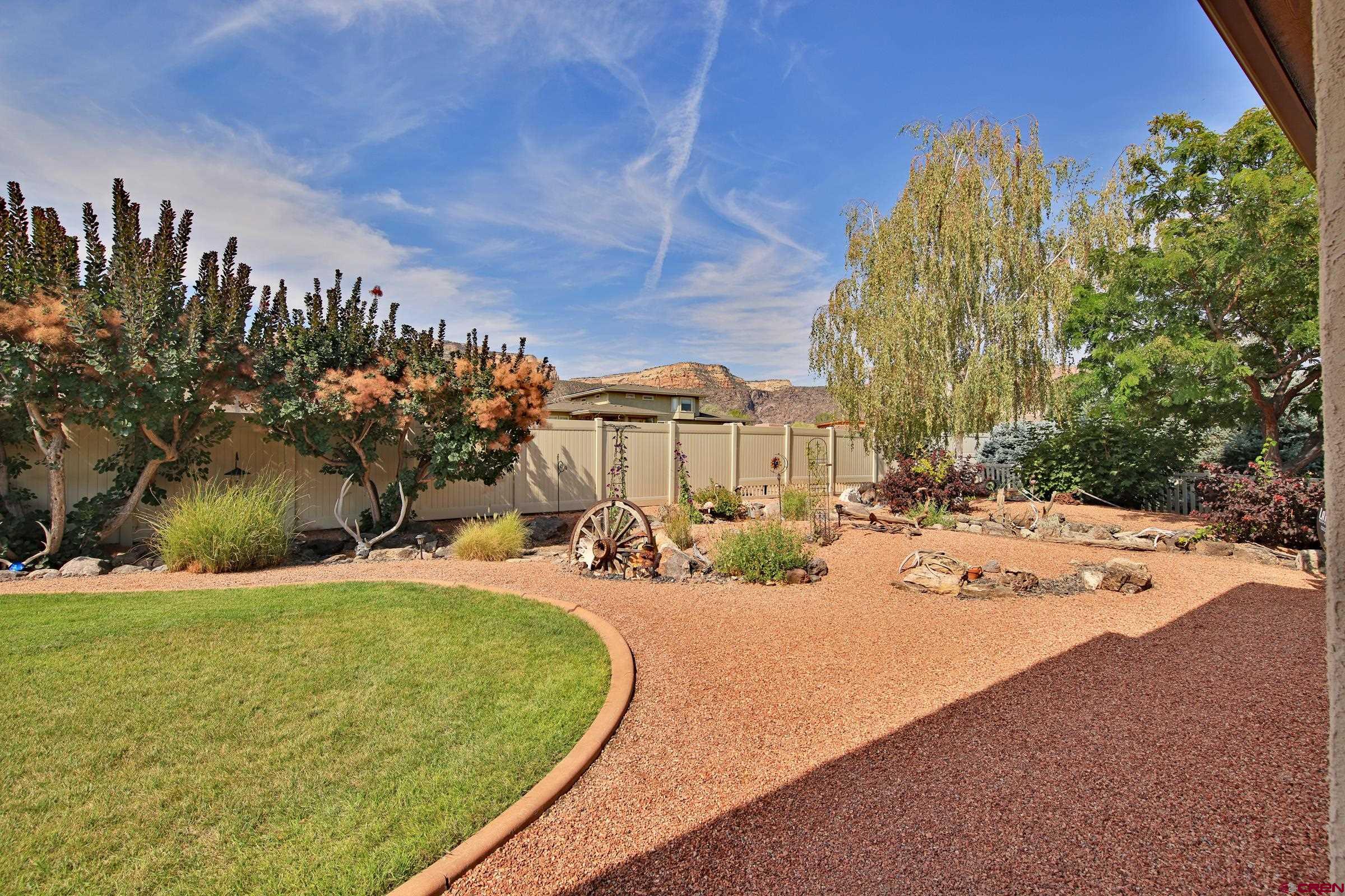 339 Canyon Rim Court Grand Junction, CO 81507 - Photo 31 of 40 a view of a backyard with plants and trees
