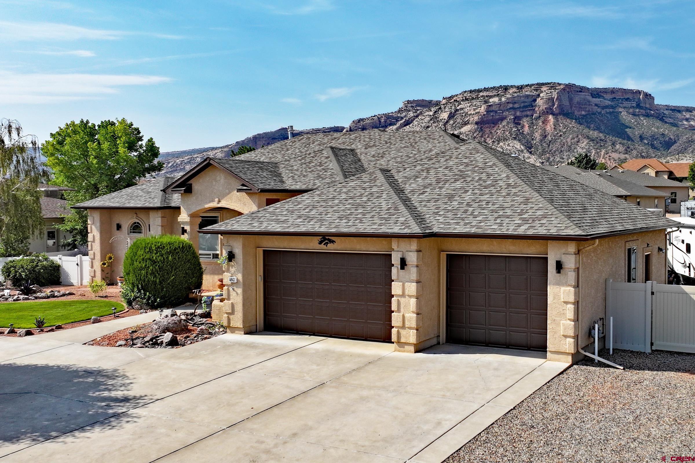 339 Canyon Rim Court Grand Junction, CO 81507 - Photo 36 of 40 a front view of a house with a yard