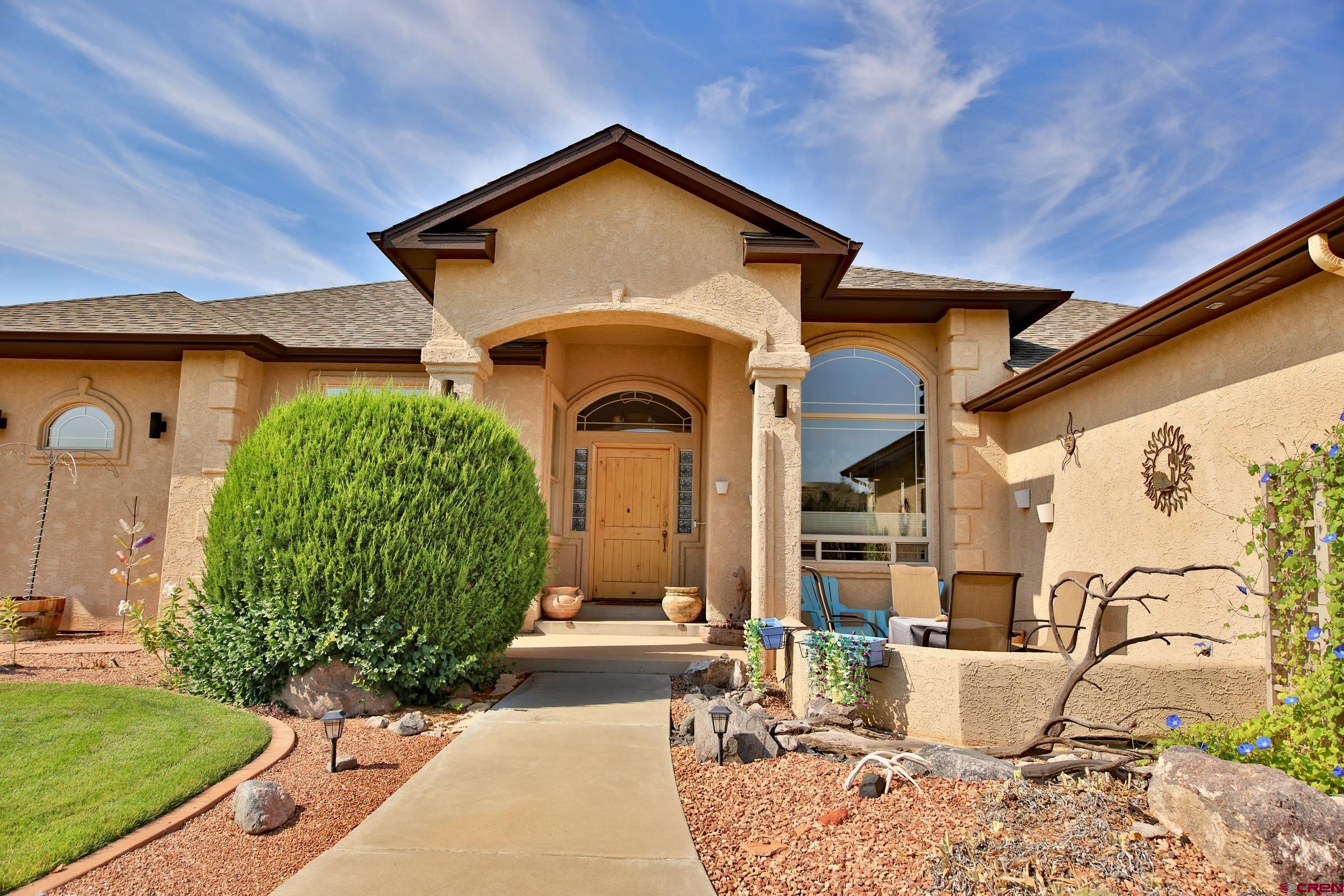 339 Canyon Rim Court Grand Junction, CO 81507 - Photo 7 of 40 a front view of a house with garden