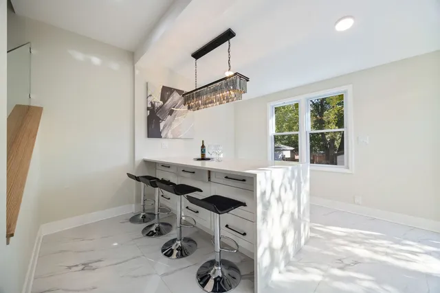 a room with a window and chairs