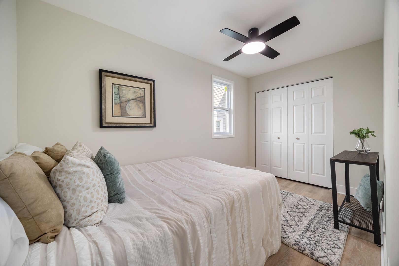 4143 North Drake Avenue Chicago, IL 60618 - Photo 17 of 40 a bedroom with a large bed and a chandelier